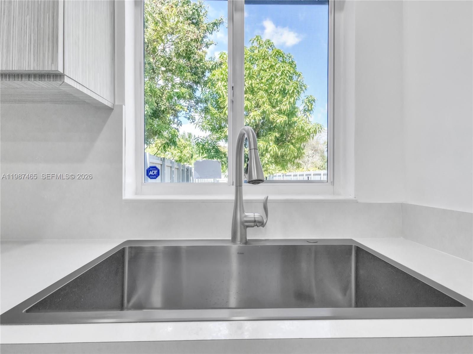 6505 Southwest 113th Place Miami, FL 33173 - Photo 6 of 25 a kitchen with a sink and window