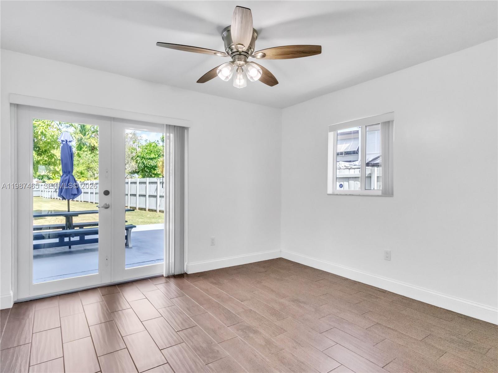 6505 Southwest 113th Place Miami, FL 33173 - Photo 7 of 25 wooden floor in an empty room with a window