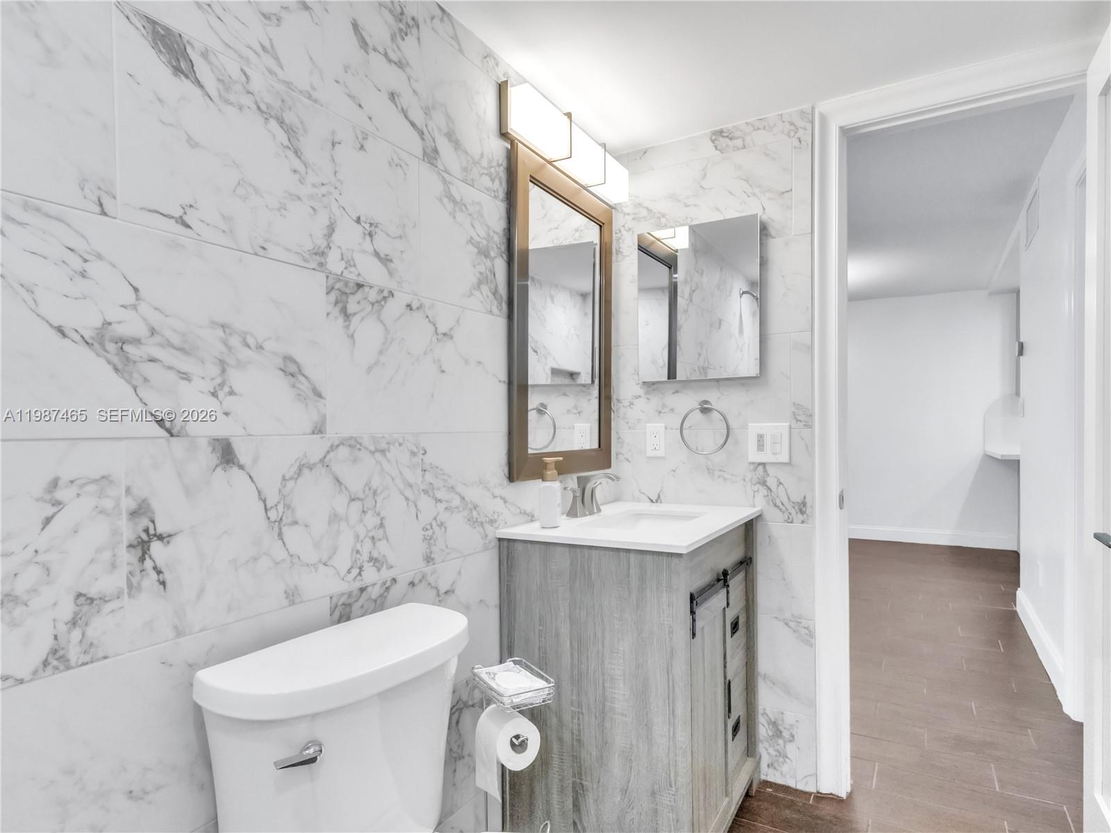 6505 Southwest 113th Place Miami, FL 33173 - Photo 10 of 25 a bathroom with a sink toilet and mirror