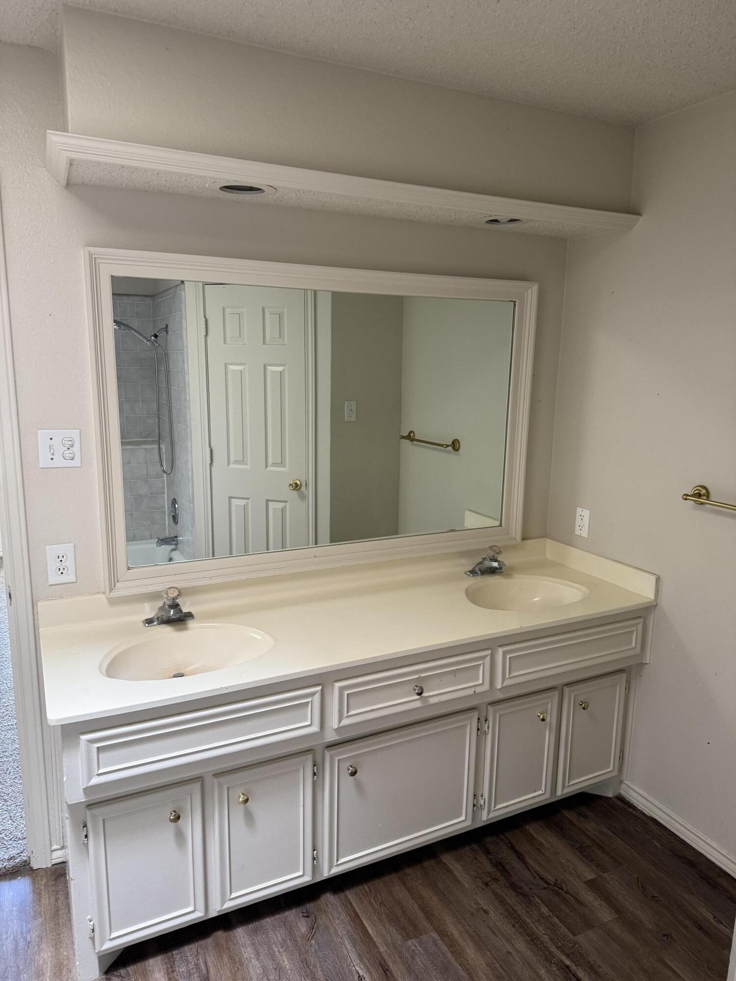 6004 68th Street Lubbock, TX 79424 - Photo 12 of 17 a bathroom with a sink and a mirror