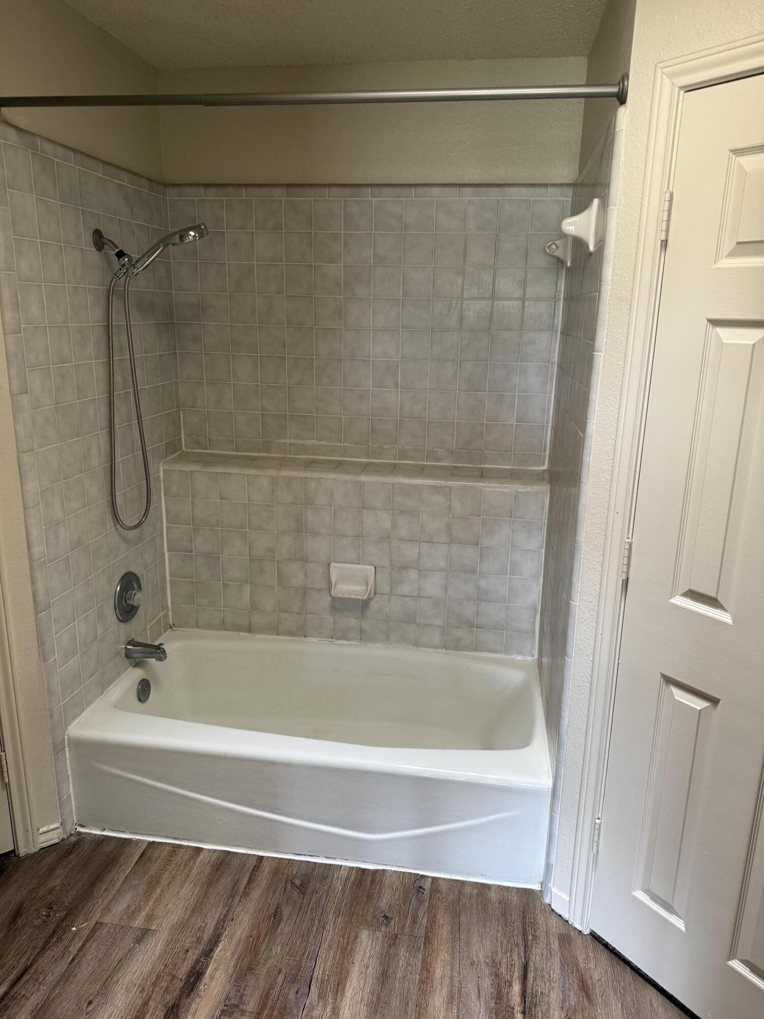 6004 68th Street Lubbock, TX 79424 - Photo 13 of 17 a bathroom with a shower and a bath tub