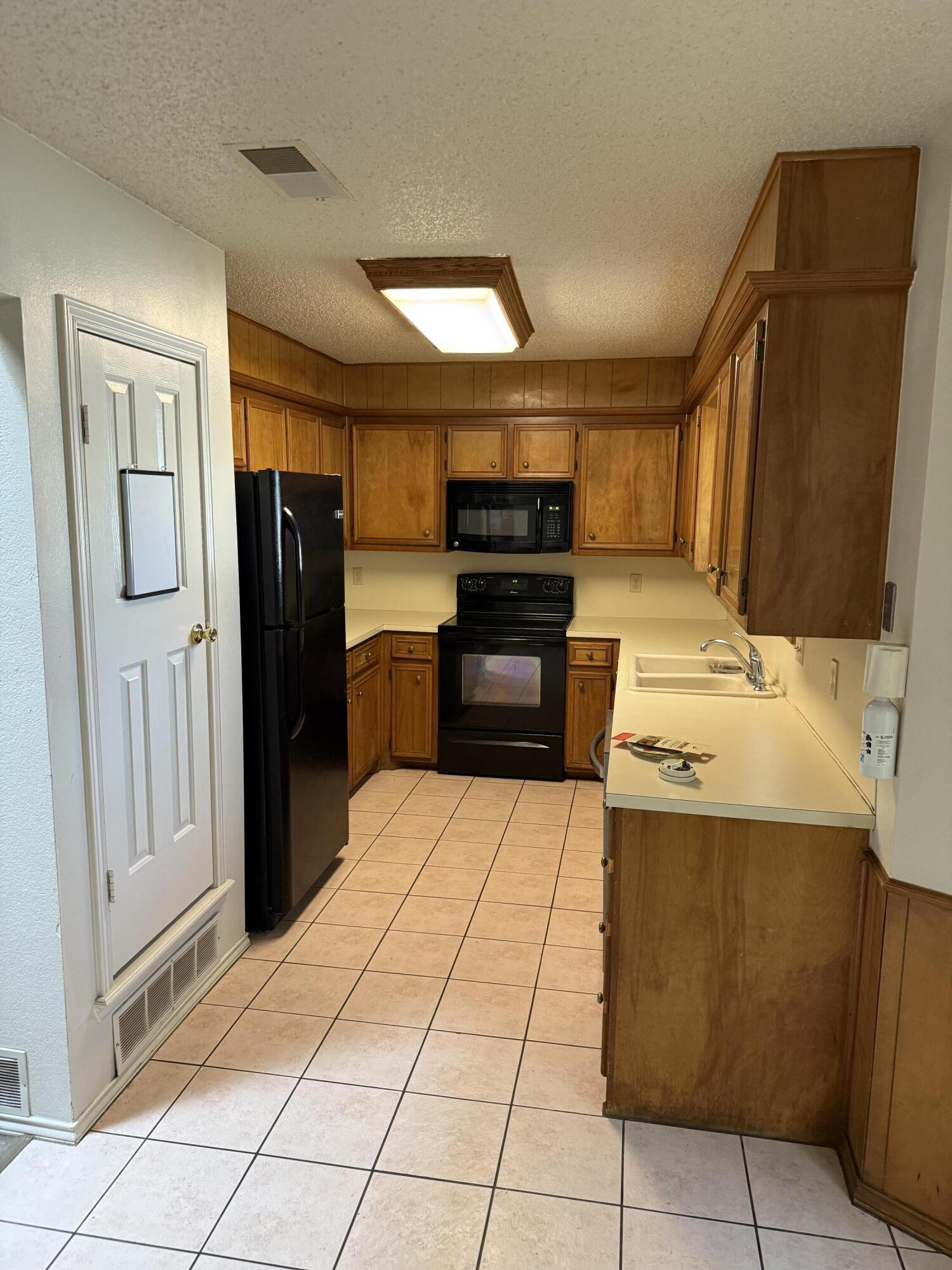 6004 68th Street Lubbock, TX 79424 - Photo 7 of 17 a kitchen with stainless steel appliances a refrigerator and a stove top oven