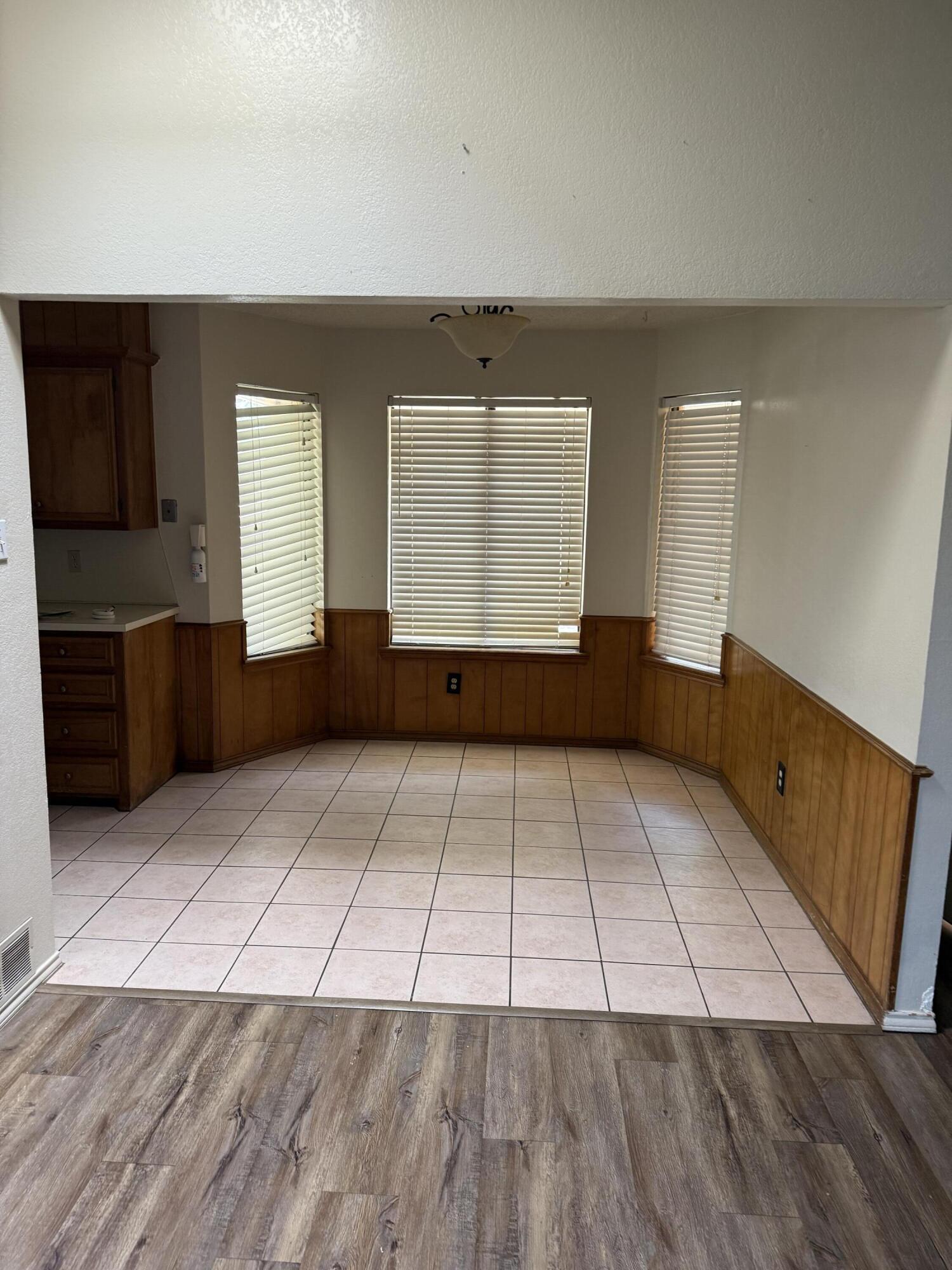 6004 68th Street Lubbock, TX 79424 - Photo 8 of 17 an empty room with windows