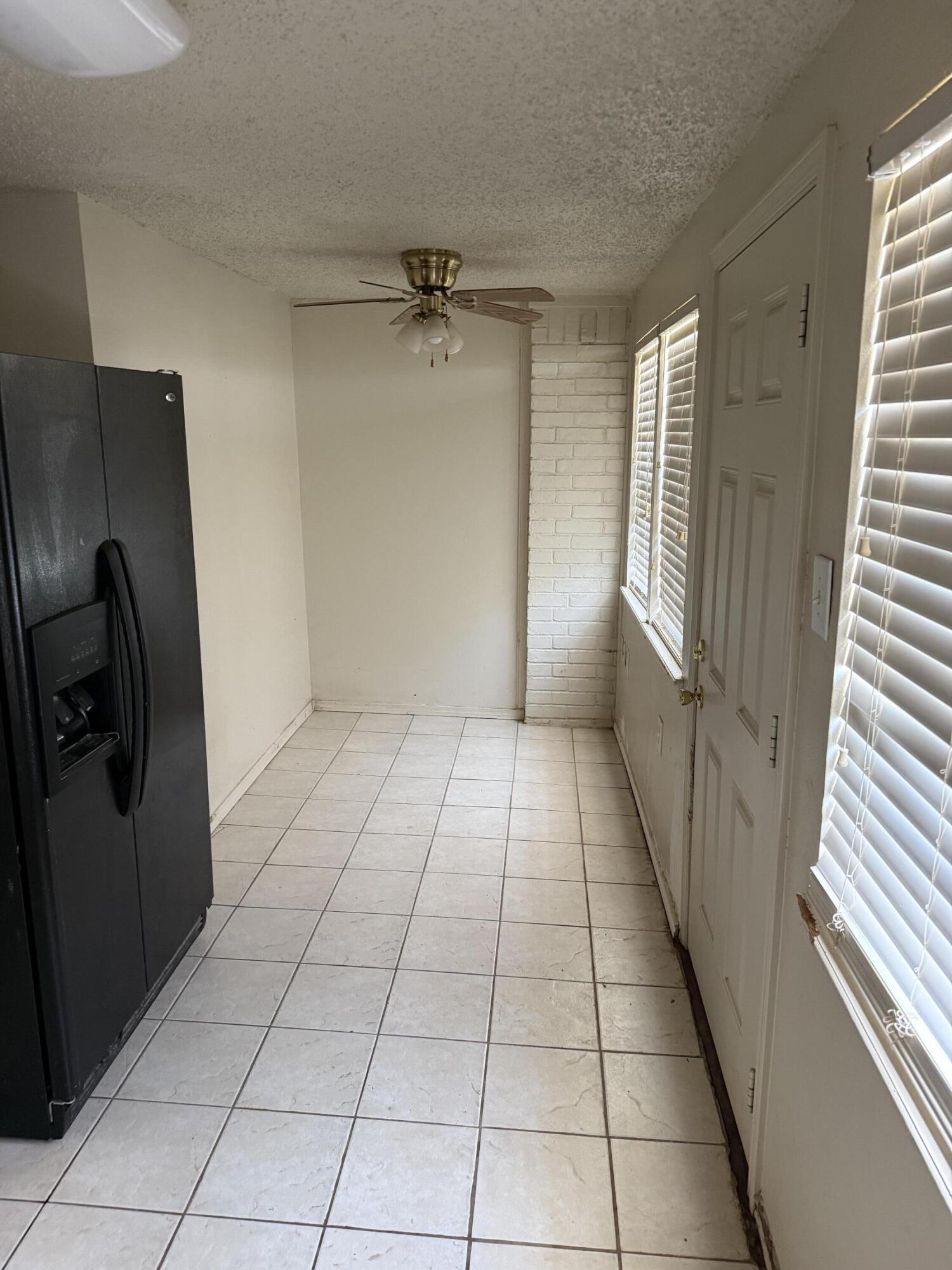 6004 68th Street Lubbock, TX 79424 - Photo 9 of 17 a view of an empty room and a window