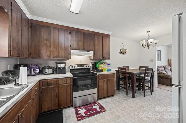 a kitchen with a sink appliances and cabinets