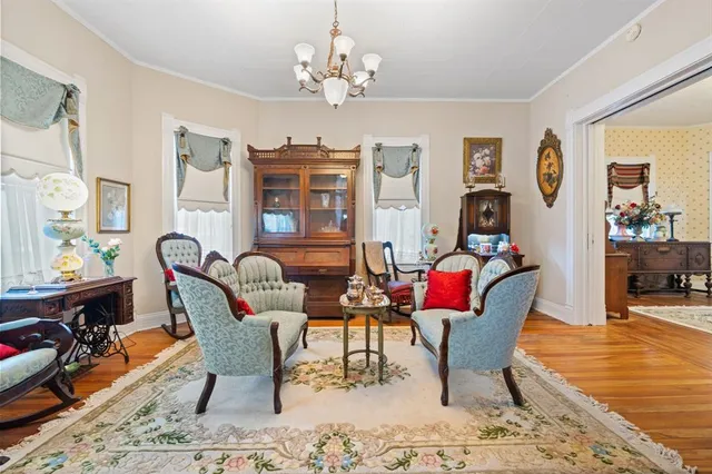 a living room with fireplace furniture and a chandelier