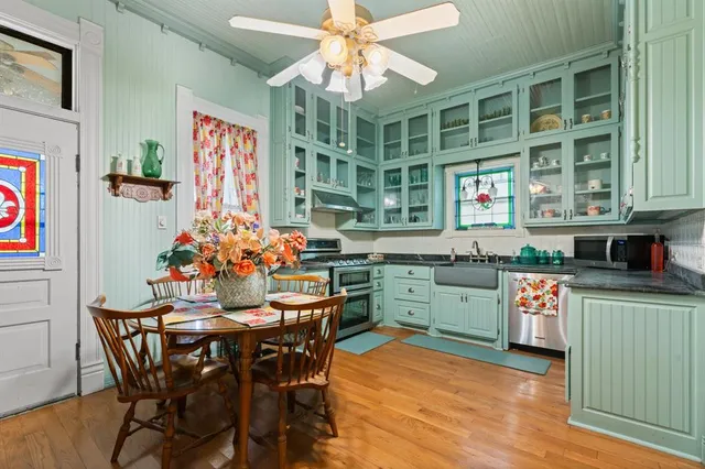 a kitchen with stainless steel appliances granite countertop a stove and cabinets