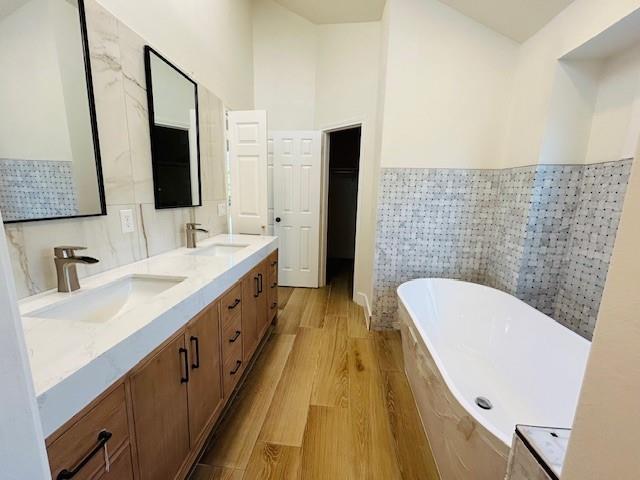 17119 Upper Bay Road Addison, TX 75001 - Photo 26 of 29 a bathroom with a double vanity sink a mirror and bathtub