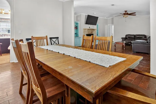 a dining room with a table chairs and kitchen view
