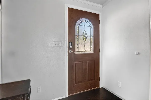 a view of a livingroom with wooden floor and a window