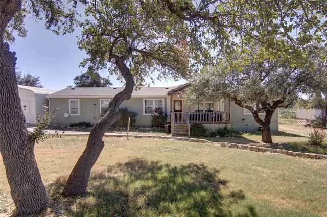 a view of a house with a tree in the background