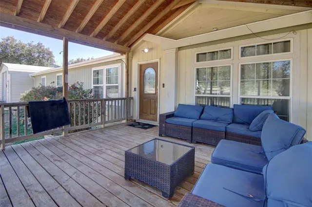 a living room with furniture a wooden floor and garden view