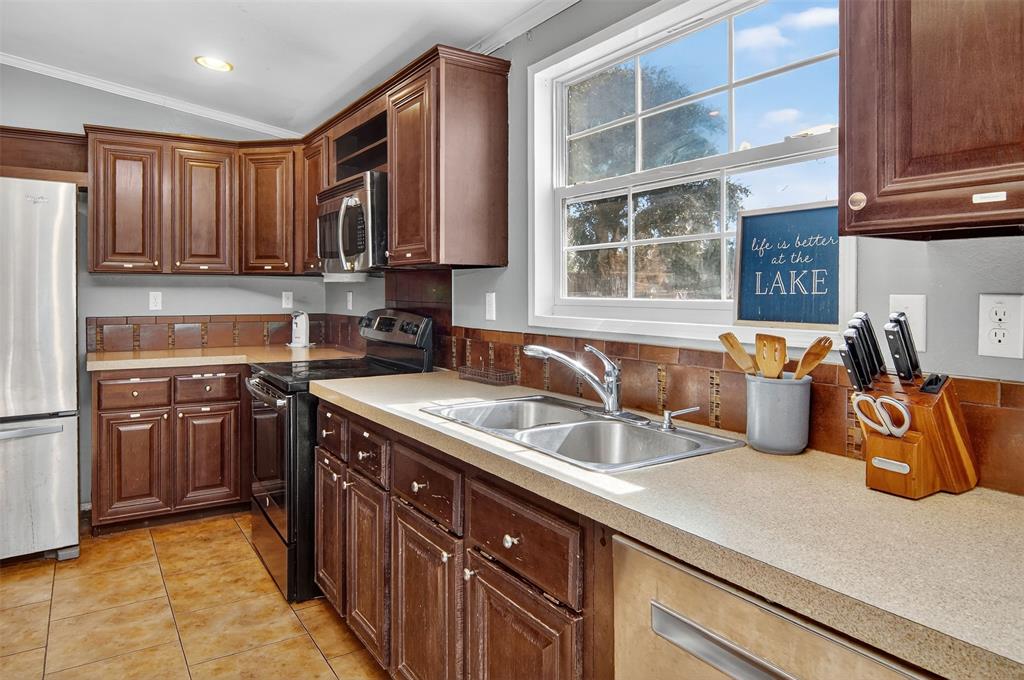 166 Quiten Lane Graham, TX 76450 - Photo 20 of 40 a kitchen with stainless steel appliances granite countertop a sink stove and cabinets