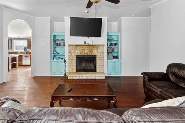 a living room with furniture fireplace and flat screen tv