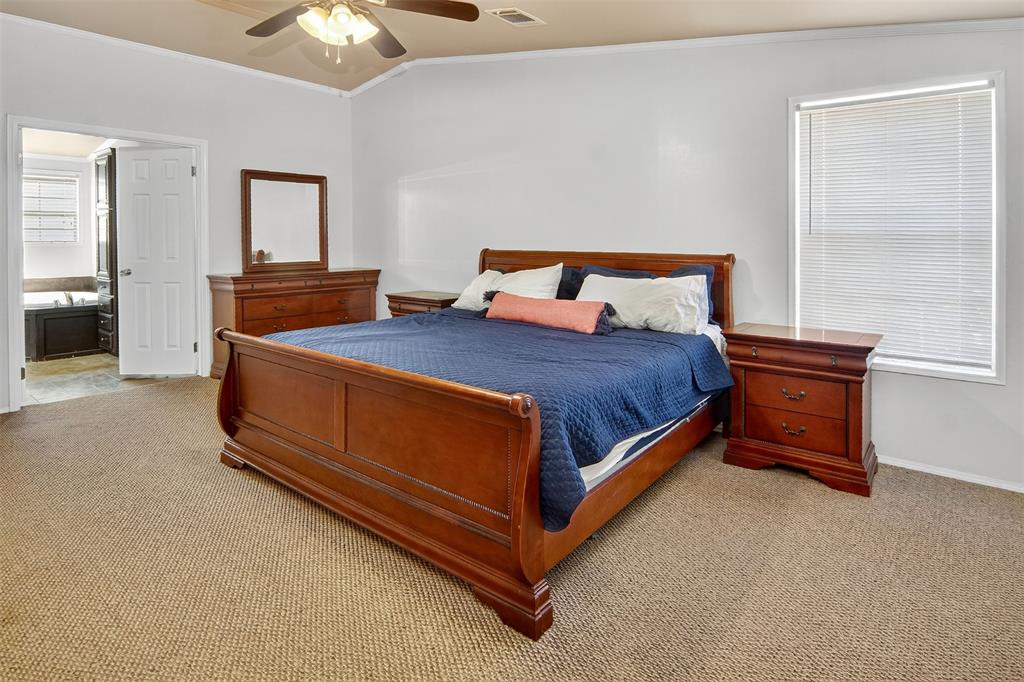 166 Quiten Lane Graham, TX 76450 - Photo 33 of 40 a bedroom with a bed and a chandelier