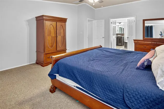a bedroom with a bed and dresser