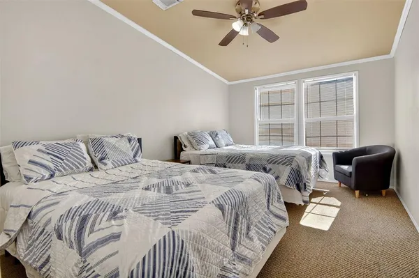 a bedroom with a bed and glass window