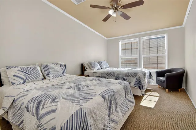 a bedroom with a bed and glass window