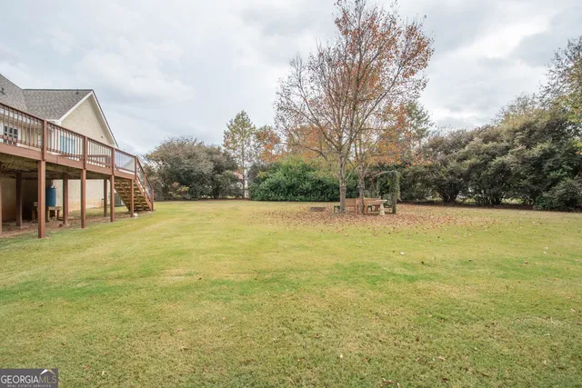 a view of a backyard with table and chairs