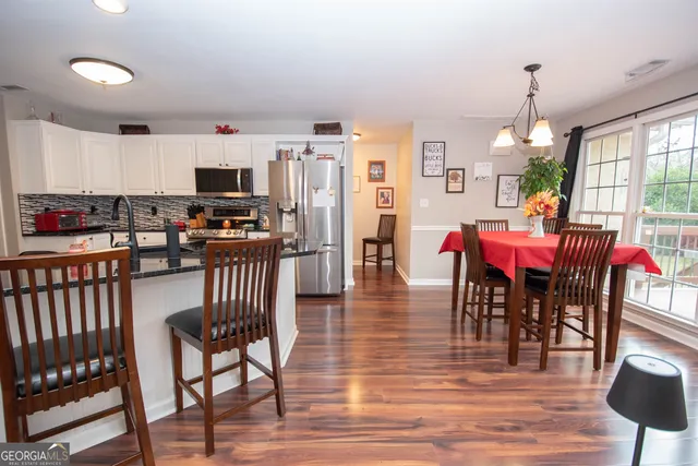 a workspace area with furniture and wooden floor