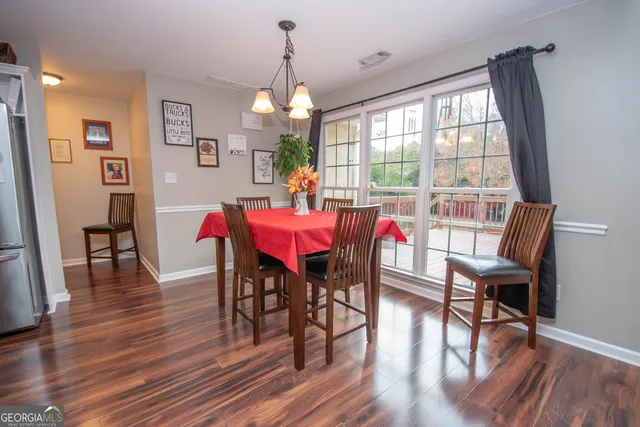 a bedroom with furniture and a wooden floor