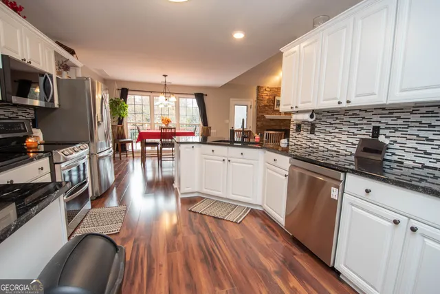 a spacious bathroom with a tub sink and mirror