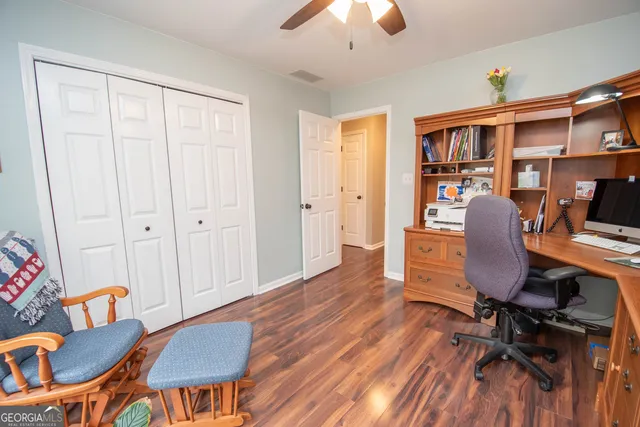 a bedroom with a bed and a wooden floor