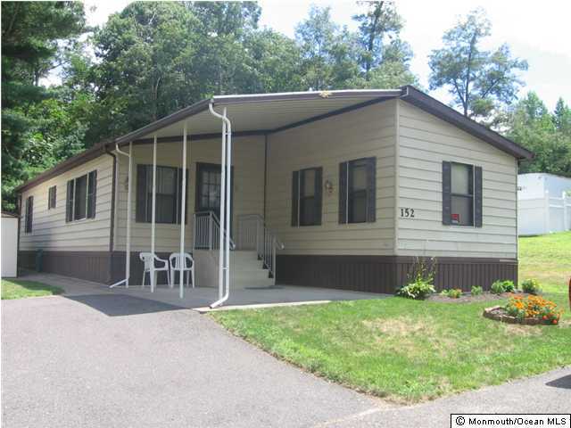 152 Village Road Morganville, NJ 07751 - Photo 1 of 3 a front view of a house with garden