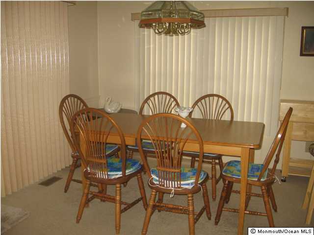 152 Village Road Morganville, NJ 07751 - Photo 3 of 3 a view of a dining room with furniture and chandelier