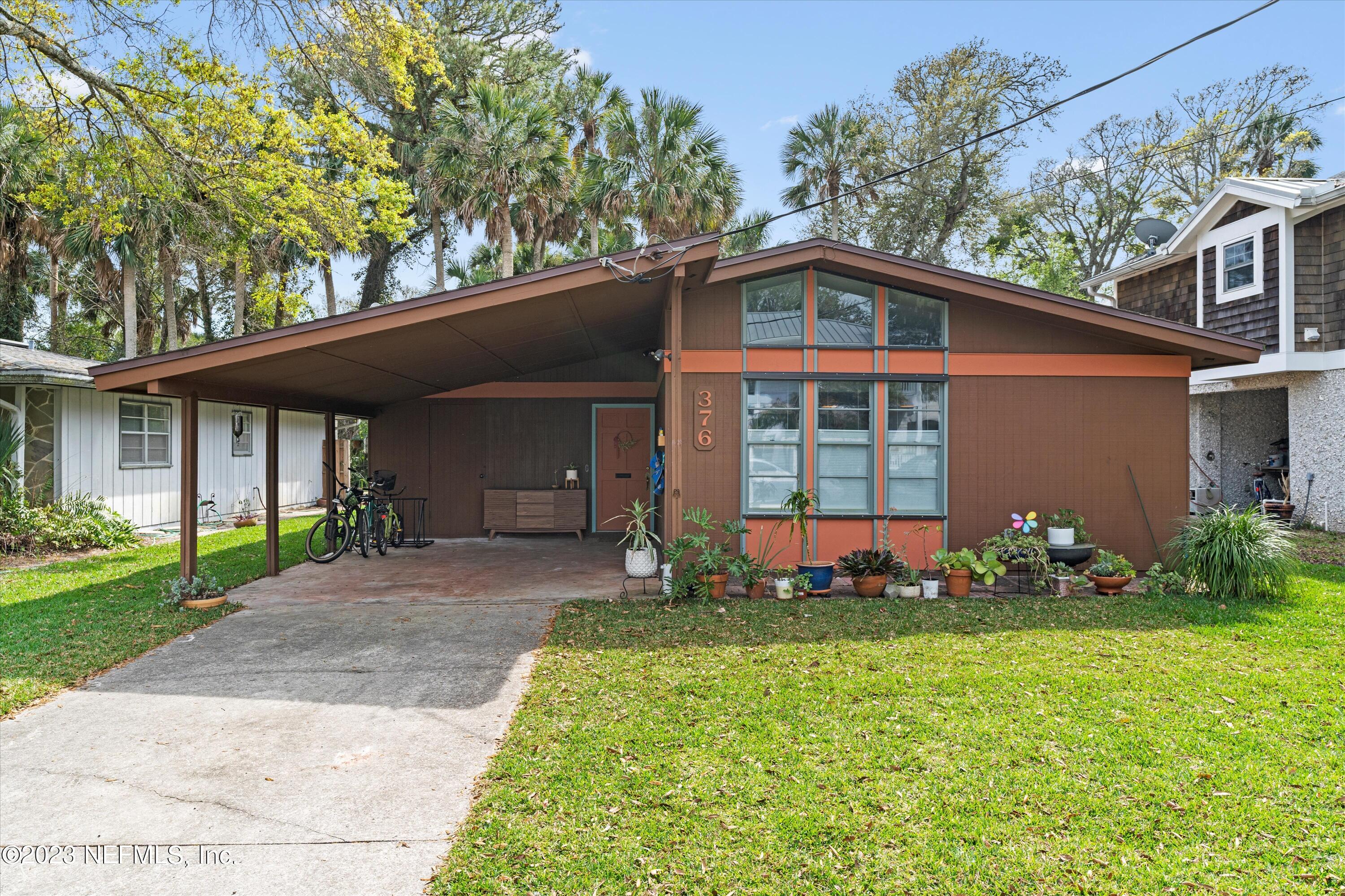 376 9th Street Atlantic Beach, FL 32233 - Photo 1 of 27 a front view of a house with garden