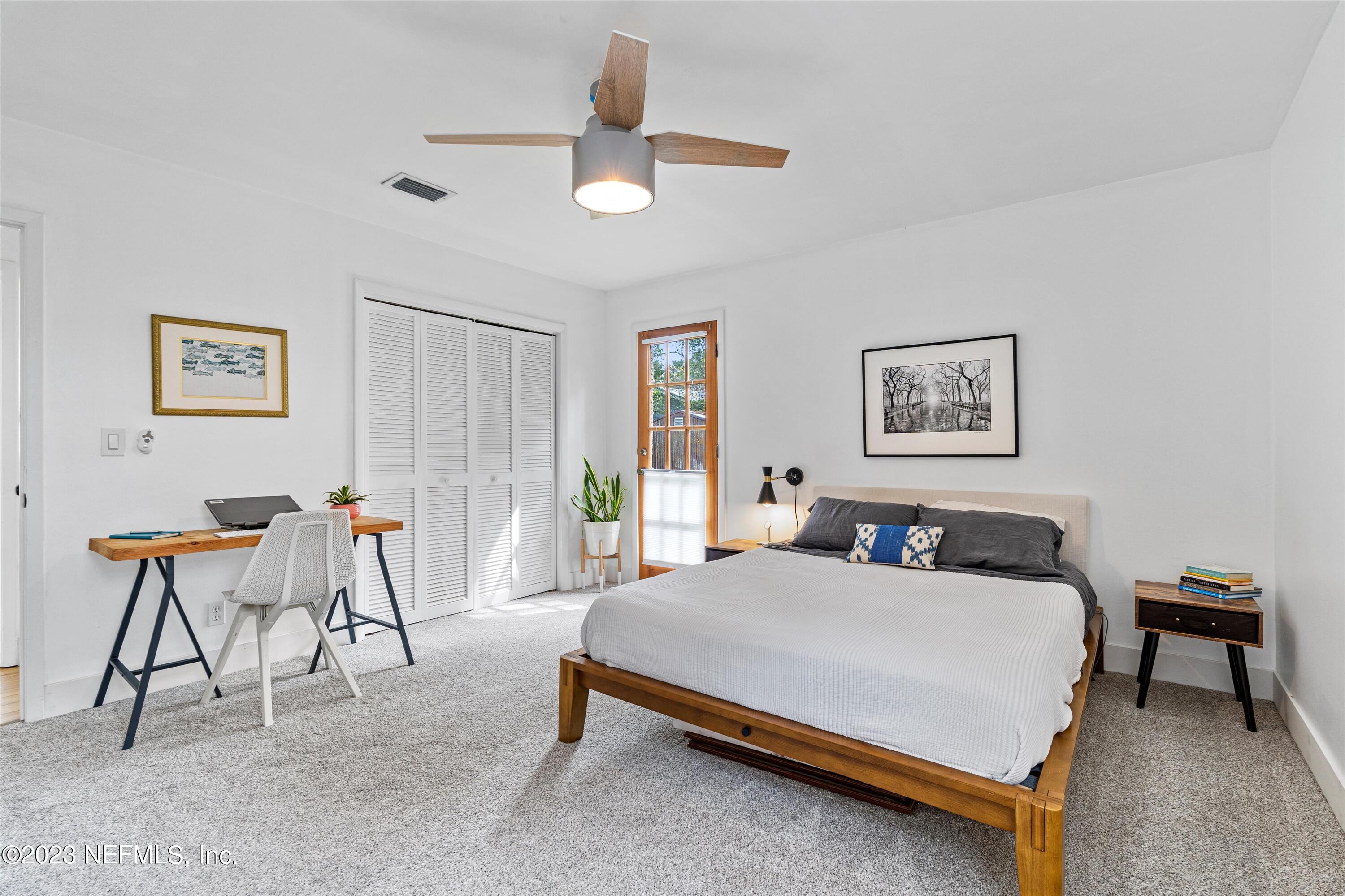 376 9th Street Atlantic Beach, FL 32233 - Photo 11 of 27 a bedroom with a bed a table and chair