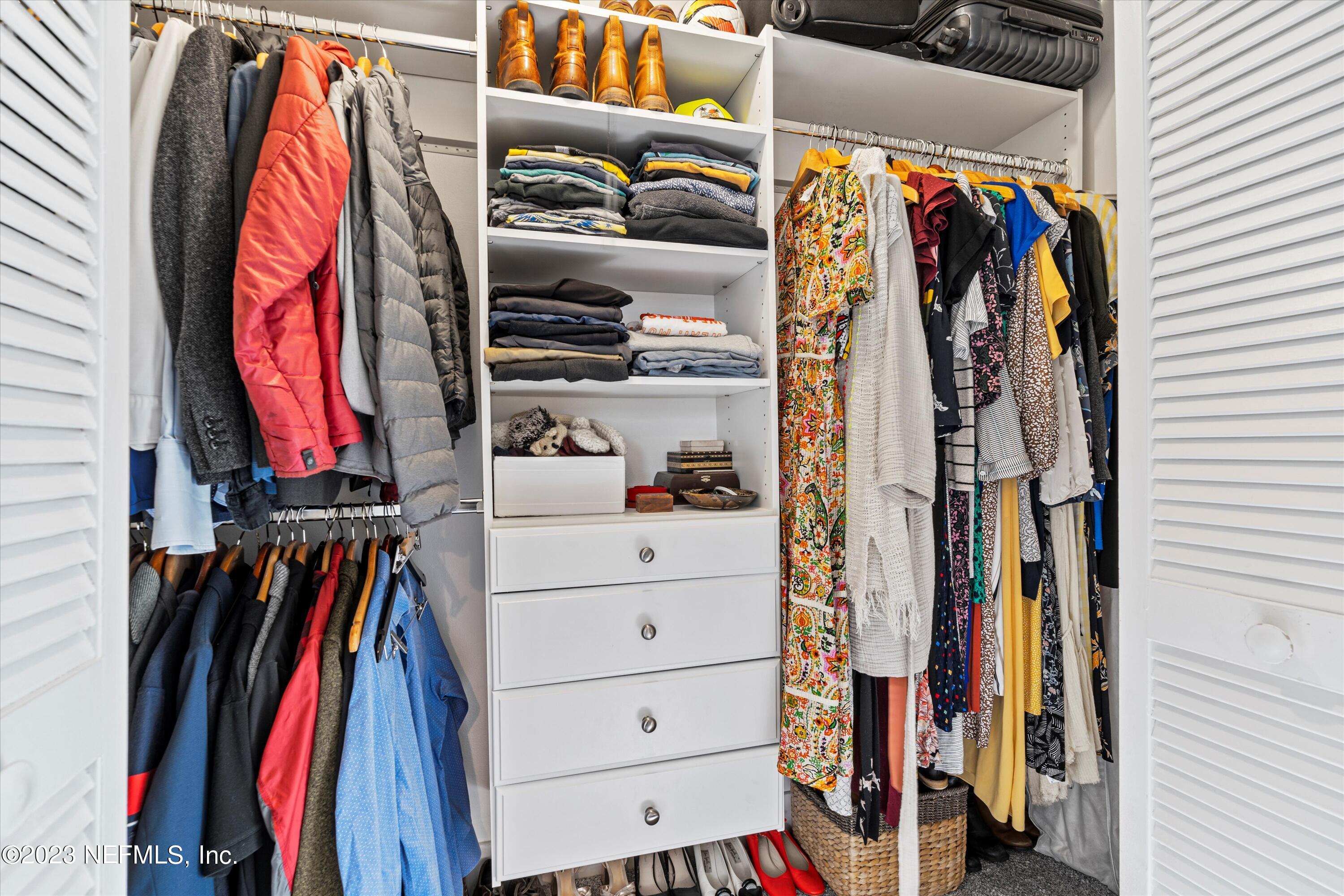 376 9th Street Atlantic Beach, FL 32233 - Photo 13 of 27 a view of walk in closet with clothes and shoes