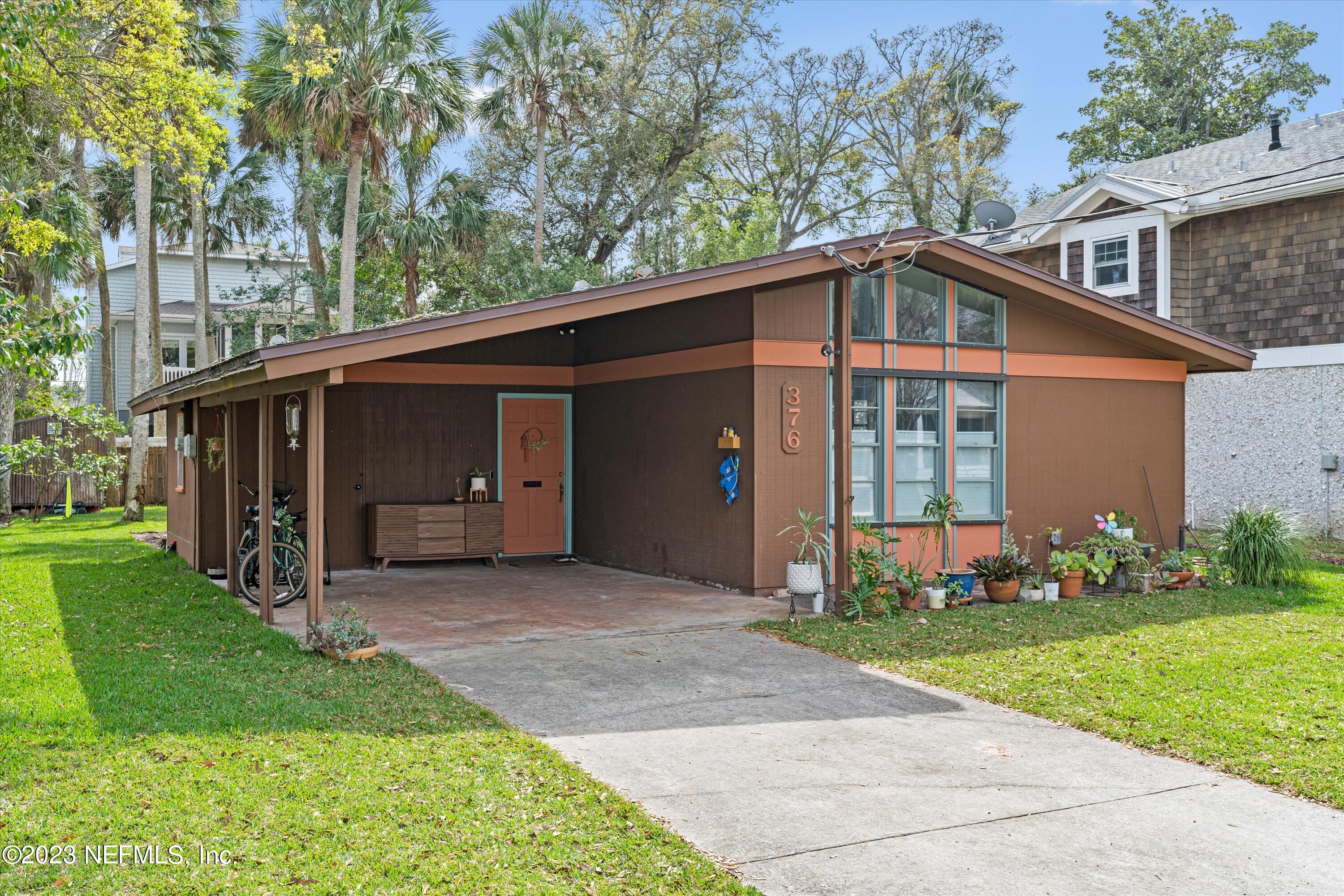 376 9th Street Atlantic Beach, FL 32233 - Photo 2 of 27 a front view of a house with a yard and garage