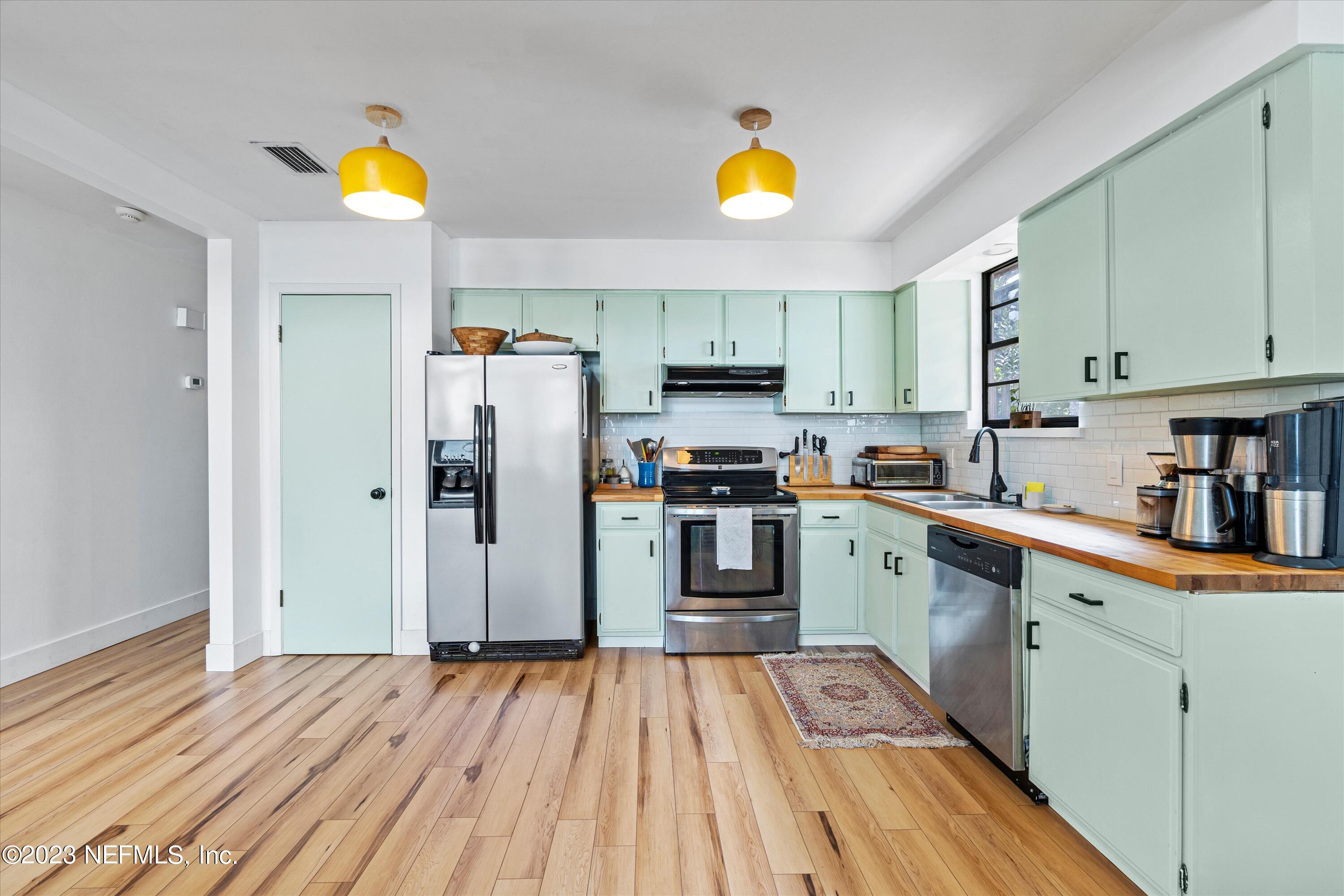 376 9th Street Atlantic Beach, FL 32233 - Photo 8 of 27 a kitchen with stainless steel appliances granite countertop a refrigerator and a sink