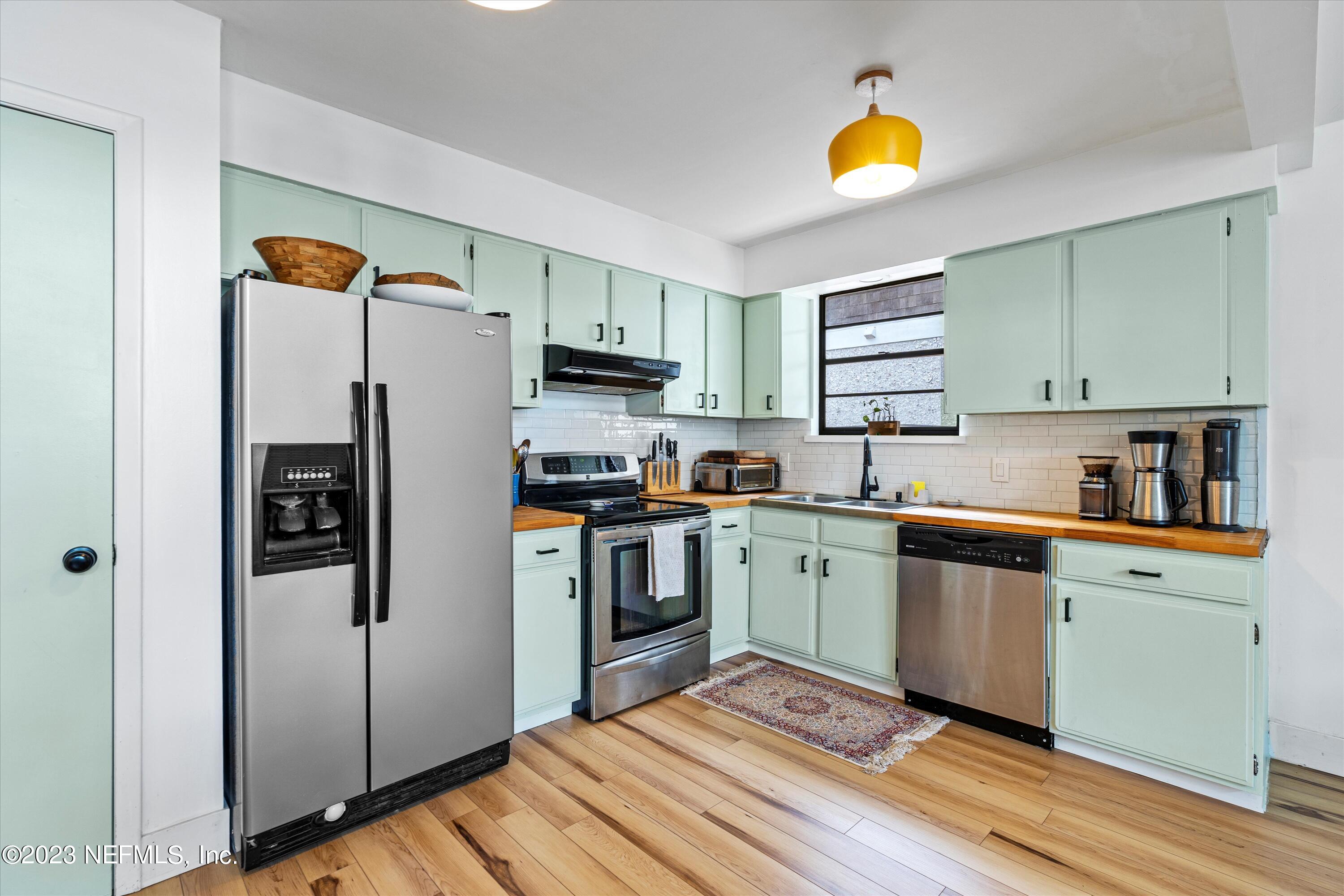 376 9th Street Atlantic Beach, FL 32233 - Photo 9 of 27 a kitchen with a refrigerator and a sink