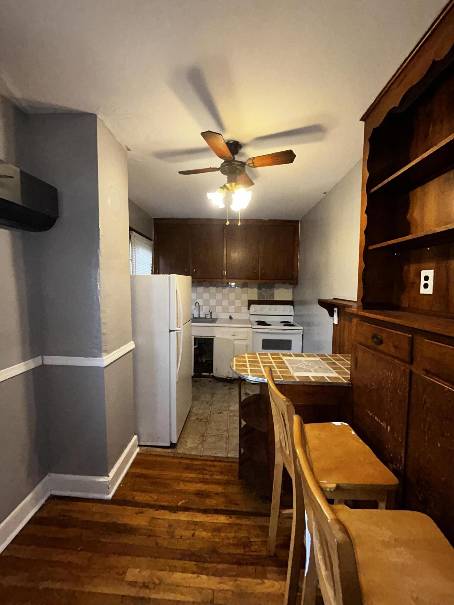 579-581 Botetourt Road Fincastle, VA 24090 - Photo 8 of 30 a kitchen with stainless steel appliances a stove a refrigerator and a fireplace