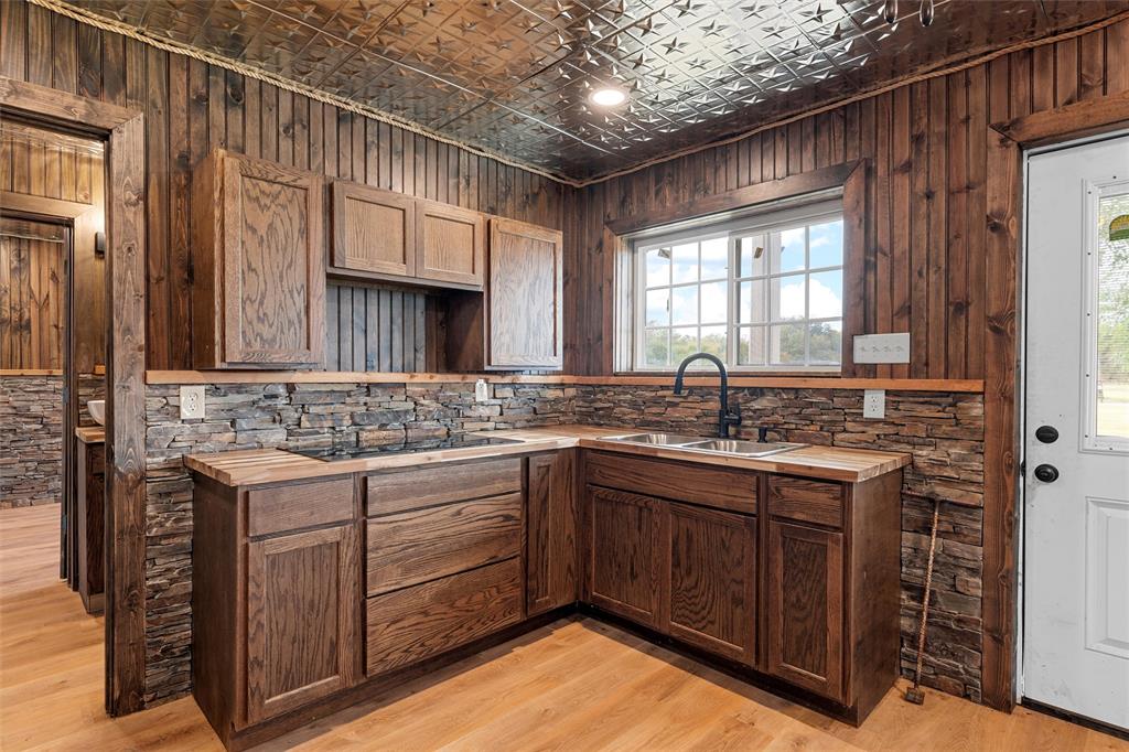 282 County Road 255 Reagan, TX 76680 - Photo 12 of 28 a kitchen with a sink stove and cabinets