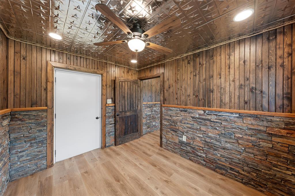 282 County Road 255 Reagan, TX 76680 - Photo 16 of 28 a view of an empty room with wooden floor and a ceiling fan