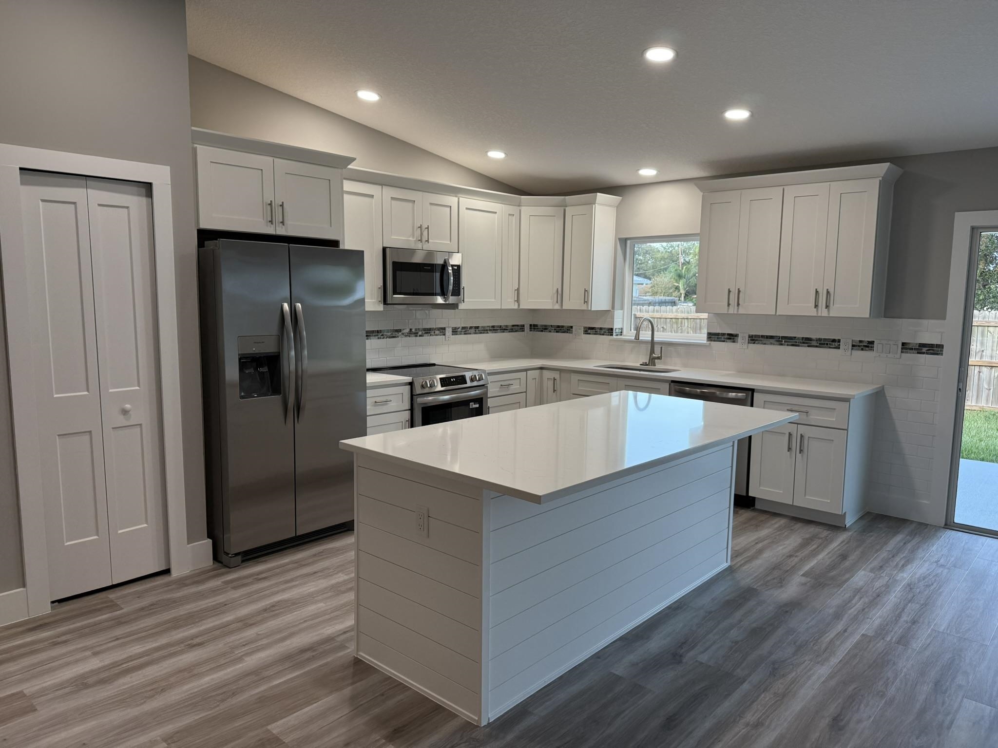 107 Lobelia Road St. Augustine, FL 32086 - Photo 5 of 15 a large kitchen with stainless steel appliances granite countertop a stove a refrigerator and a sink