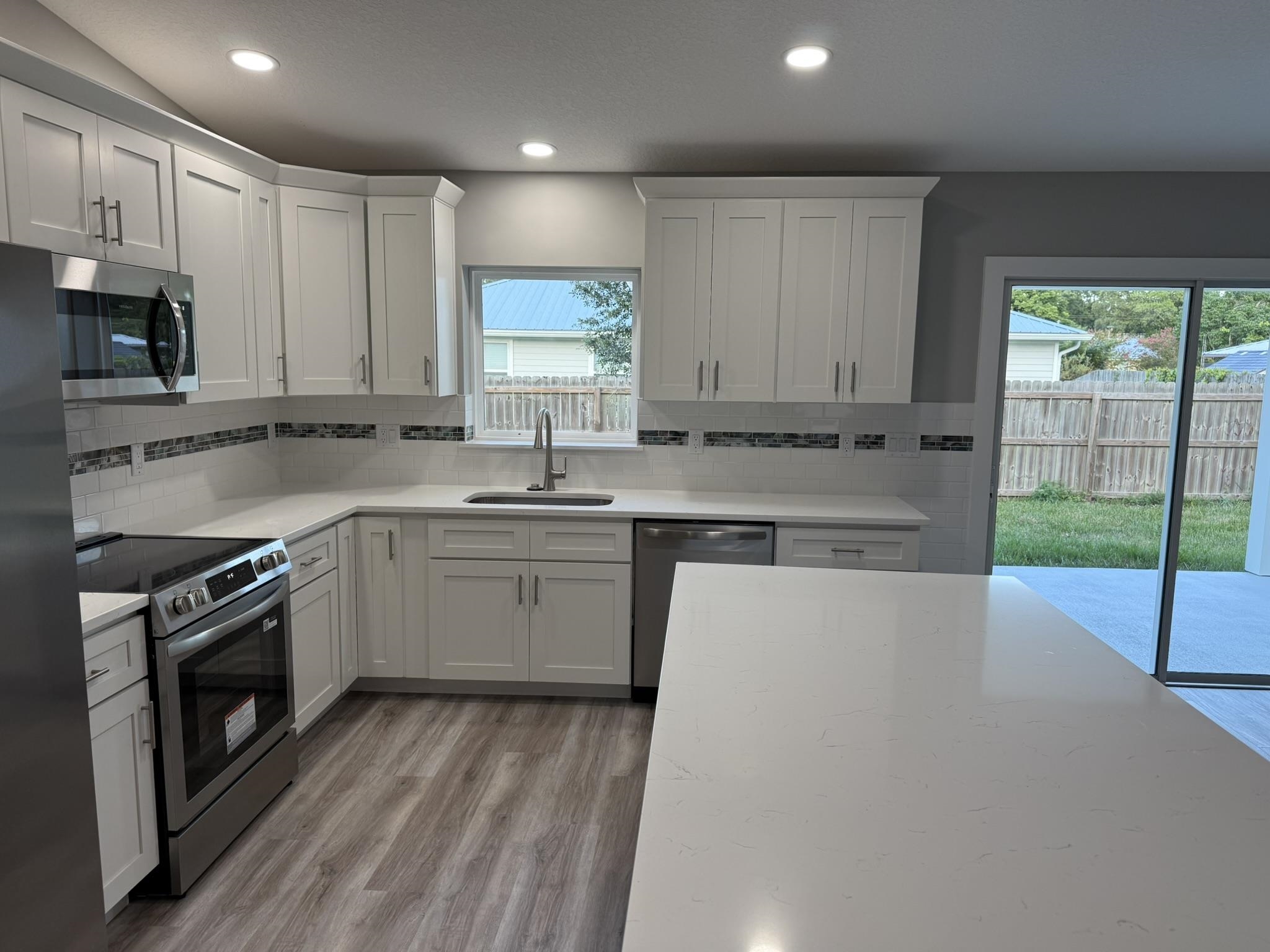 107 Lobelia Road St. Augustine, FL 32086 - Photo 7 of 15 a kitchen with a sink cabinets stainless steel appliances and window