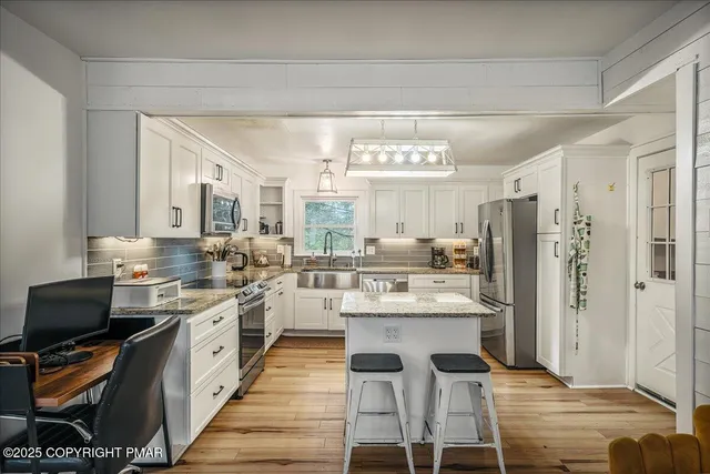 a kitchen with lots of counter top space and appliances