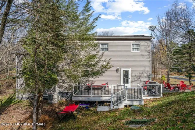 a backyard of a house with table and chairs