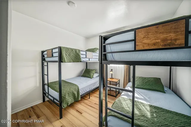 a bedroom with a bed and a view of painting