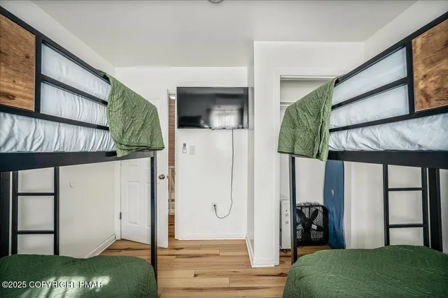 a view of a livingroom with furniture and floor to ceiling window
