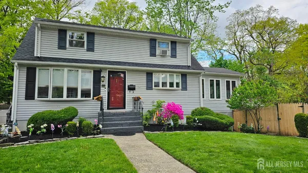 a front view of a house with a yard and a garden