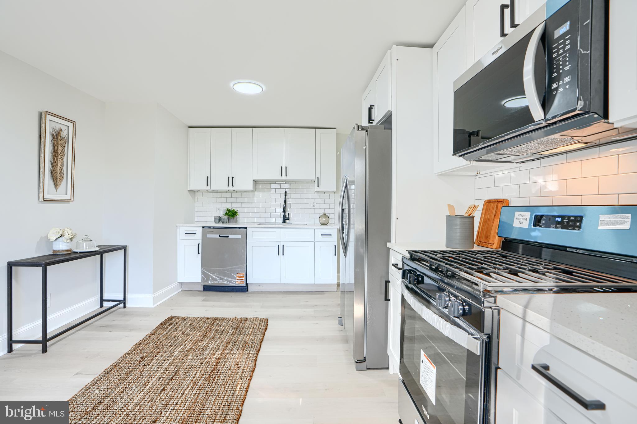 212 North Marlyn Avenue Essex, MD 21221 - Photo 18 of 54 a kitchen with stainless steel appliances granite countertop a stove a sink and a refrigerator
