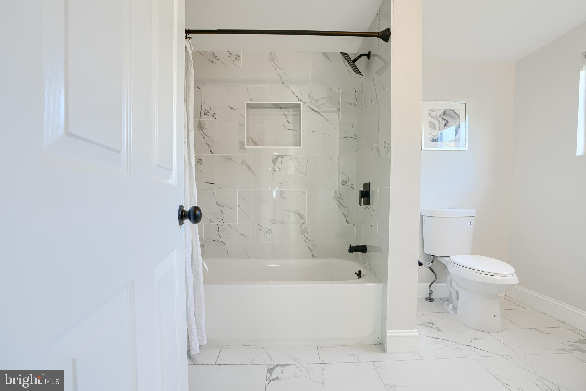 212 North Marlyn Avenue Essex, MD 21221 - Photo 30 of 54 a bathroom with a toilet and shower