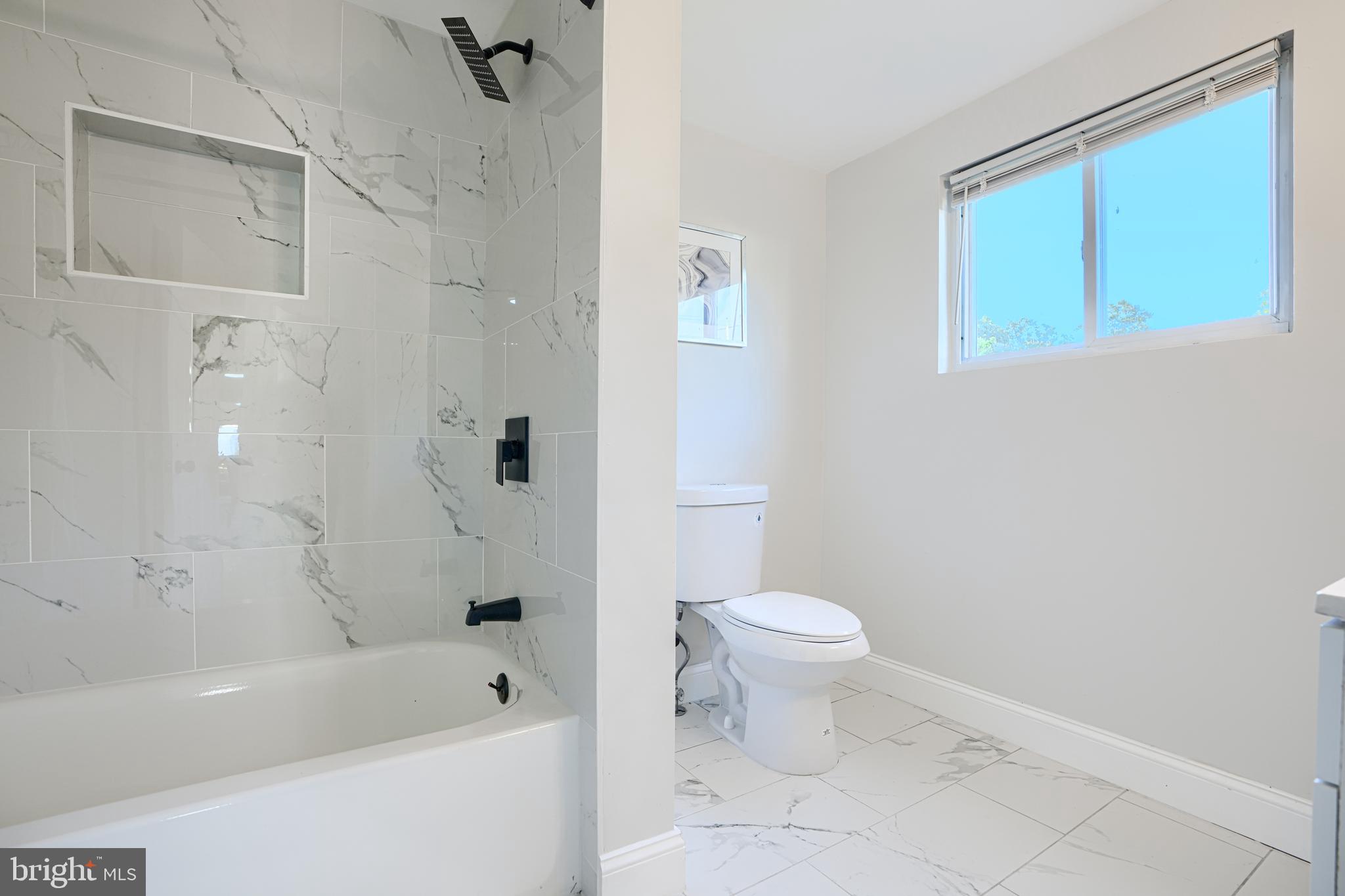 212 North Marlyn Avenue Essex, MD 21221 - Photo 31 of 54 a bathroom with a toilet and a bathtub