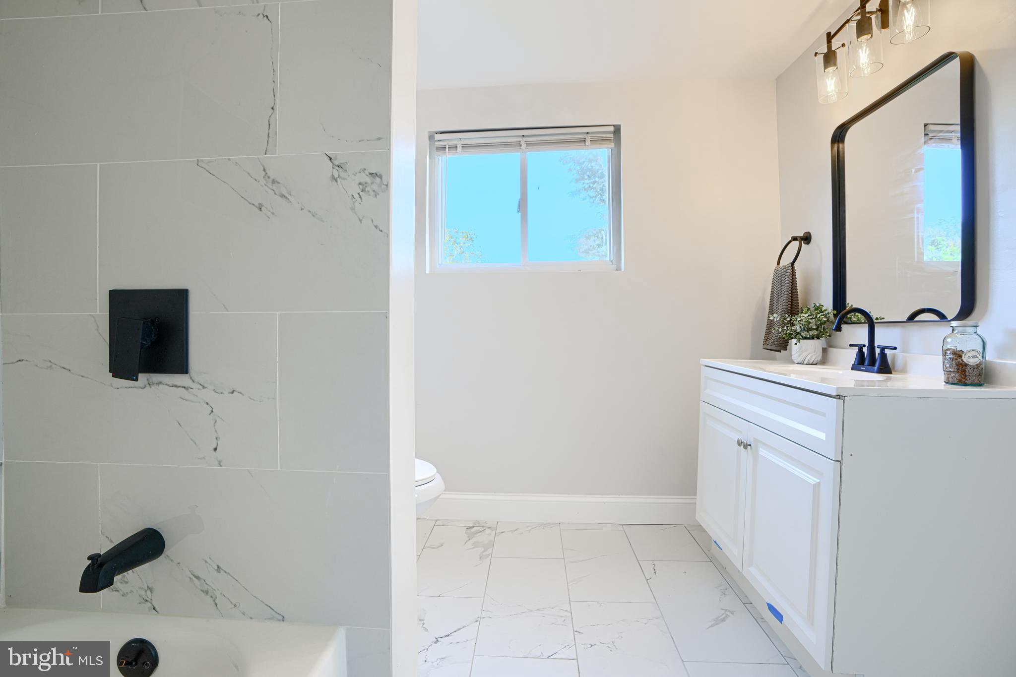 212 North Marlyn Avenue Essex, MD 21221 - Photo 33 of 54 a bathroom with a sink a vanity and a mirror