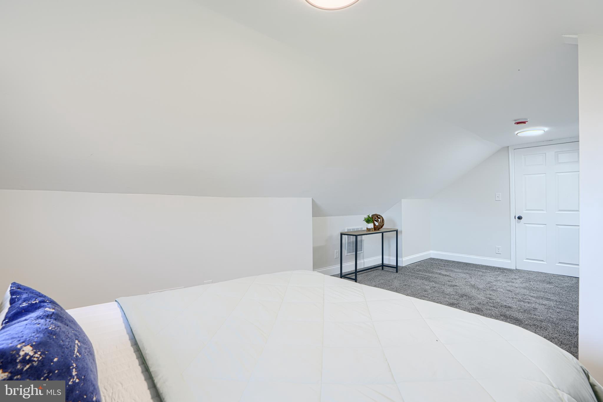 212 North Marlyn Avenue Essex, MD 21221 - Photo 43 of 54 a bedroom with a bed and a potted plant